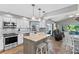Modern kitchen with an island, bar stools, stainless steel appliances, and ample counter space at 1225 Neapolitan Rd, Punta Gorda, FL 33983