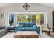 Bright and airy living room with a large bay window offering views of the lush tropical landscaping at 1225 Neapolitan Rd, Punta Gorda, FL 33983