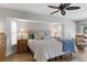Serene main bedroom with neutral tones, a ceiling fan, and a cozy sitting area bathed in natural light at 1225 Neapolitan Rd, Punta Gorda, FL 33983