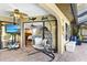 Cozy patio with a hanging chair, ceiling fan, and view of the adjacent room through sliding glass doors at 1225 Neapolitan Rd, Punta Gorda, FL 33983