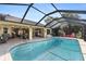 Gorgeous pool area with a screened enclosure, lounge seating, and seamless transition to the covered patio at 1225 Neapolitan Rd, Punta Gorda, FL 33983