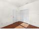 Bedroom featuring hardwood floors, bi-fold closet, and natural light at 12285 Canavese Ln, Venice, FL 34293