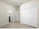 An empty bedroom offers a large closet, tile flooring, and access to the en suite bathroom at 12285 Canavese Ln, Venice, FL 34293
