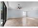 Spacious living room with large sliding doors, tile flooring, and a ceiling fan at 12285 Canavese Ln, Venice, FL 34293