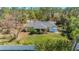Aerial view of a charming home with well-maintained yard and mature trees at 1333 Mendavia Ter, North Port, FL 34286
