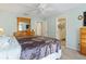 Comfortable bedroom featuring a ceiling fan and an ensuite bathroom with a glass shower at 1333 Mendavia Ter, North Port, FL 34286