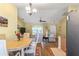 Open-concept living and dining area featuring natural light, wood-look flooring, and comfortable furniture at 1333 Mendavia Ter, North Port, FL 34286