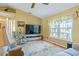 Comfortable living room with a large window, plush seating, and a ceiling fan at 1333 Mendavia Ter, North Port, FL 34286
