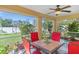 Outdoor living area with a screened porch, ceiling fan, and views of the lush backyard at 1333 Mendavia Ter, North Port, FL 34286