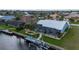 Rear of property on canal featuring a screened in lanai, pool and private dock at 1334 Via Milanese, Punta Gorda, FL 33950