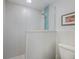Modern bathroom featuring a glass-enclosed shower with blue accent tile and a white tiled surround at 1334 Via Milanese, Punta Gorda, FL 33950