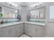 Elegant bathroom features dual sinks, decorative mirrors, and a tiled backsplash for a spa-like feel at 1334 Via Milanese, Punta Gorda, FL 33950