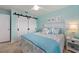 Beautiful bedroom featuring a coastal theme, white headboard, and barn door closet at 1334 Via Milanese, Punta Gorda, FL 33950