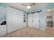 Bright, tiled bedroom with a murphy bed, built in shelving, and barn door closet at 1334 Via Milanese, Punta Gorda, FL 33950
