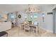 Cozy dining area features a stylish chandelier and plantation shutters, creating a light-filled space at 1334 Via Milanese, Punta Gorda, FL 33950