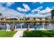 Waterfront property featuring a private dock with a boat lift and scenic views of the water at 1334 Via Milanese, Punta Gorda, FL 33950