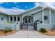 Charming home featuring a light blue exterior, metal roof, decorative gate and landscaped front yard at 1334 Via Milanese, Punta Gorda, FL 33950