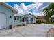 Charming single-Gathering home featuring light blue exterior paint, metal roof and manicured landscaping at 1334 Via Milanese, Punta Gorda, FL 33950