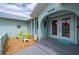 Charming front entrance featuring a light blue exterior, decorative double doors, and cozy seating area at 1334 Via Milanese, Punta Gorda, FL 33950