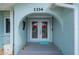 Close up of the front entrance featuring arched alcove and decorative double doors with heart decorations at 1334 Via Milanese, Punta Gorda, FL 33950