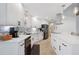 Bright kitchen features white cabinetry, stainless steel appliances, and mosaic backsplash at 1334 Via Milanese, Punta Gorda, FL 33950
