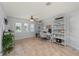 Bright office space featuring a desk, decorative shelves, and plantation shutters for privacy at 1334 Via Milanese, Punta Gorda, FL 33950