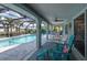 Inviting screened patio with comfortable seating, a ceiling fan, and a view of the pool and canal at 1334 Via Milanese, Punta Gorda, FL 33950