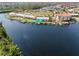 Aerial view of a waterfront condo with boat docks, beautiful landscaping, and lake view at 1344 Rock Dove Ct # D102, Punta Gorda, FL 33950