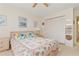 Bedroom with ceiling fan, closet, and a bed with floral pattern bedding at 1344 Rock Dove Ct # D102, Punta Gorda, FL 33950