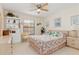 Bedroom with ceiling fan, large window, and a bed with colorful bedding at 1344 Rock Dove Ct # D102, Punta Gorda, FL 33950