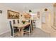 Dining area with seating for six, a decorative light fixture, and open access to the kitchen at 1344 Rock Dove Ct # D102, Punta Gorda, FL 33950