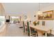 View of the dining and living area with waterfront views from the adjacent enclosed lanai at 1344 Rock Dove Ct # D102, Punta Gorda, FL 33950