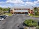 Exterior view of a condo with carports, an American flag, and beautiful landscaping at 1344 Rock Dove Ct # D102, Punta Gorda, FL 33950
