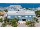 Exterior view of Fisherman's Village with gray roof, blue siding, and palm trees at 1344 Rock Dove Ct # D102, Punta Gorda, FL 33950