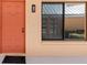 Welcoming front entrance with a vibrant coral door, sleek black window trim, and a 'welcome' mat at 1344 Rock Dove Ct # D102, Punta Gorda, FL 33950