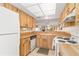 Bright kitchen showcases light wood cabinets, white appliances, and tile flooring, with a breakfast bar at 1344 Rock Dove Ct # D102, Punta Gorda, FL 33950