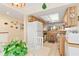 Cozy kitchen features wood cabinets, white appliances, tile floors, with view to breakfast area at 1344 Rock Dove Ct # D102, Punta Gorda, FL 33950