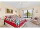 Bedroom with a large window offering waterfront views and a view of the mature palms at 1344 Rock Dove Ct # D102, Punta Gorda, FL 33950