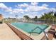 Community pool with brick border, lake view, and beautiful landscaping at 1344 Rock Dove Ct # D102, Punta Gorda, FL 33950
