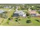 Aerial view of home showcasing pool, screened-in lanai, backyard, and well-maintained landscaping at 1417 Carswell St, Port Charlotte, FL 33953