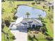 Stunning aerial view of home, landscaped yard, and serene pond providing a peaceful outdoor retreat at 1417 Carswell St, Port Charlotte, FL 33953