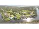 Aerial view of the waterfront neighborhood highlighting lush landscaping and waterways at 1417 Carswell St, Port Charlotte, FL 33953