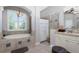 Luxurious bathroom features a soaking tub, walk-in shower, and elegant fixtures at 1417 Carswell St, Port Charlotte, FL 33953