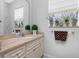 Bathroom featuring a sink with marble countertop, vanity, mirror, and window above the toilet at 1417 Carswell St, Port Charlotte, FL 33953