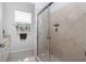 Well-lit bathroom featuring a tile shower with glass door and window above toilet at 1417 Carswell St, Port Charlotte, FL 33953