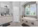 Luxurious bathroom features a soaking tub, and elegant fixtures at 1417 Carswell St, Port Charlotte, FL 33953