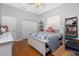 Cozy bedroom with hardwood floors, a ceiling fan, and natural light at 1417 Carswell St, Port Charlotte, FL 33953