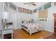Charming bedroom featuring wood floors, decorated with framed posters and a large window at 1417 Carswell St, Port Charlotte, FL 33953