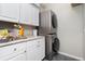 Laundry room with stacked washer and dryer and storage cabinets at 1417 Carswell St, Port Charlotte, FL 33953