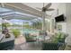 Screened in patio with comfortable outdoor furniture overlooking the pool and lake at 1417 Carswell St, Port Charlotte, FL 33953